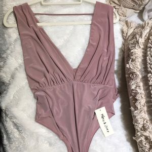 Brand new never worn body suit.